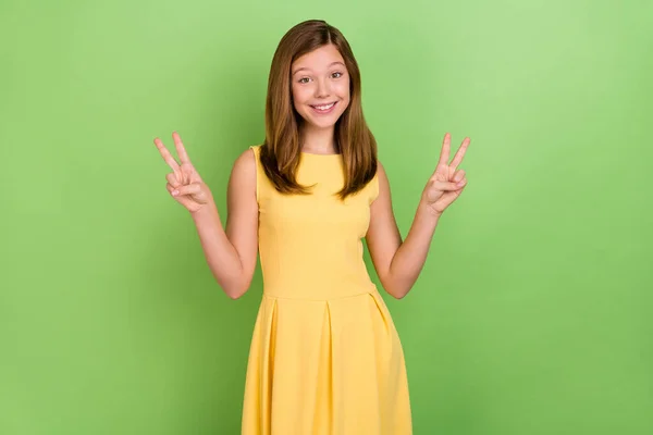 Photo of young adorable girl show fingers peace cool v-symbol vacation trip isolated over green color background — Foto de Stock