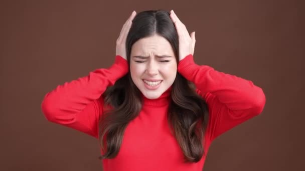 Frustrated lady hide ears loud noise scream isolated brown color background — Stockvideo