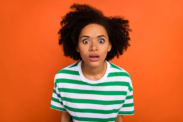 Portrait of attractive funny nervous scared wavy-haired girl staring eyes isolated over bright orange color background —  Fotos de Stock
