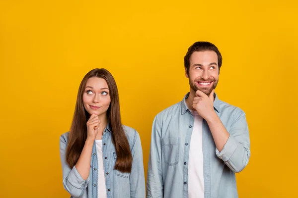 Photo of smart millennial brown hairdo couple look promo wear jeans shirts isolated on yellow background — Foto Stock
