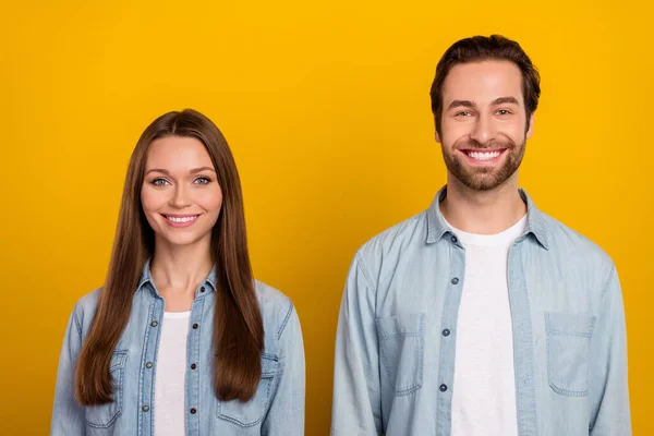 Photo of impressed young brown hairdo couple wear jeans shirts isolated on yellow background — Foto Stock
