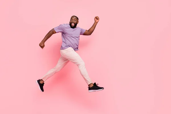 Tamanho do corpo de comprimento total vista de cara alegre atraente pulando voo de corrida isolado sobre cor pastel rosa fundo — Fotografia de Stock