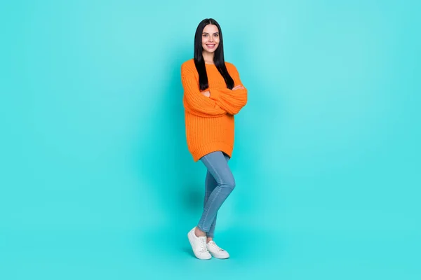 Photo of sweet confident woman wear orange sweater arms crossed smiling isolated turquoise color background —  Fotos de Stock
