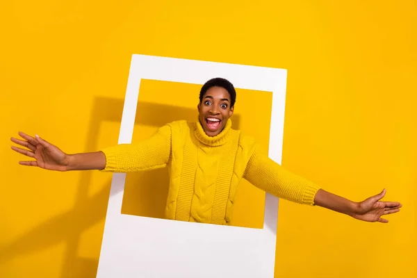 Portrait of attractive cheerful funky girl coming out frame comfort zone isolated over bright yellow color background — ストック写真