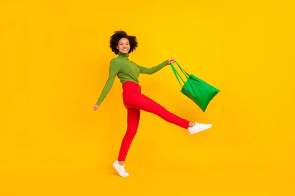 Full size profile side photo of young excited lady have fun walk shopping grocery isolated over yellow color background — Fotografia de Stock