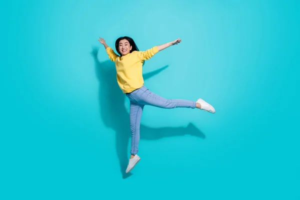 Full length photo of cute charming lady dressed yellow sweater jumping high dancing isolated turquoise color background — Stock Fotó