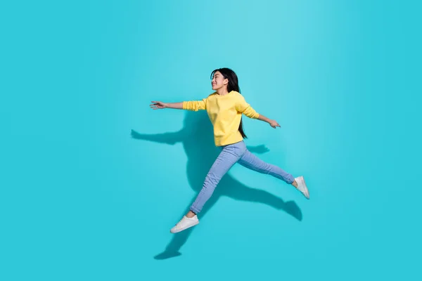 Full length photo of sweet cute lady dressed yellow sweater jumping running empty space isolated turquoise color background — Stok fotoğraf