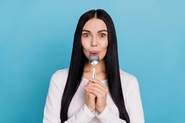 Photo of millennial sweet brunette lady lick spoon wear white cloth isolated on blue color background — Photo