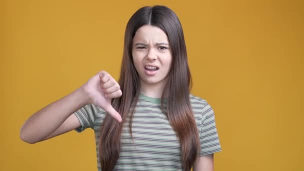 Unhappy schoolchild make thumb down symbol isolated shine color background — Vídeo de stock