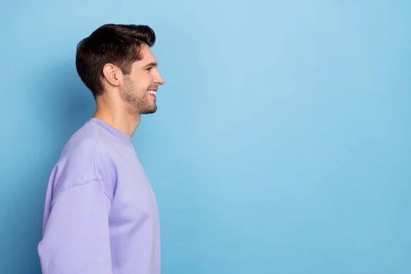 Profile side view portrait of attractive cheerful guy copy blank space ad isolated over bright blue color background — ストック写真