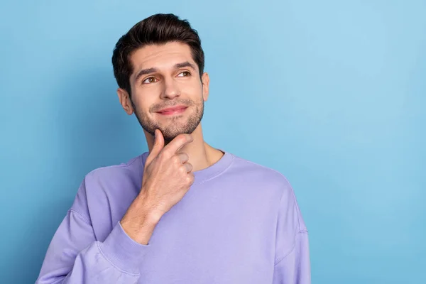 Photo of cute millennial brunet guy look empty space wear pullover isolated on blue color background — Stock Photo, Image