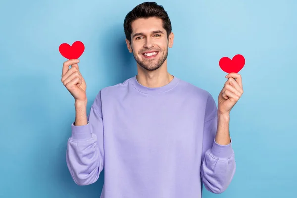 Photo of funny millennial brunet guy hold heart wear sweater isolated on blue color background — 스톡 사진