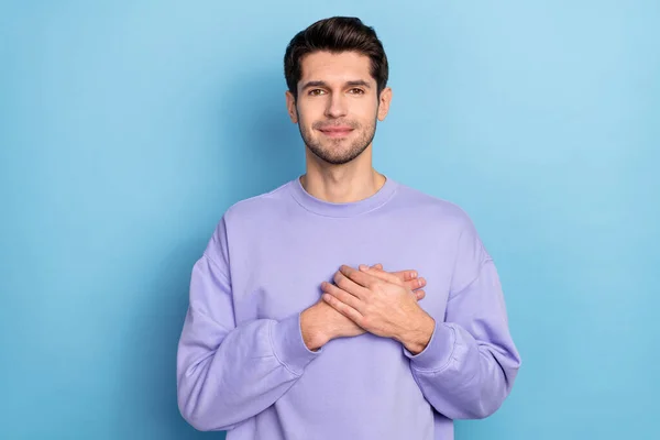 Photo of cute millennial brunet guy hold palms wear sweater isolated on blue color background — Foto Stock