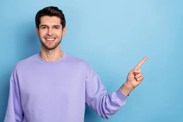 Photo of nice young brunet guy index promo wear sweatshirt isolated on blue color background — Foto de Stock
