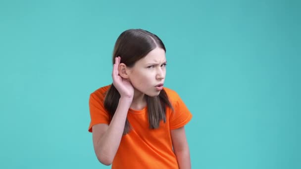 Schoolchild try listen information not hear isolated cyan color background — Stockvideo