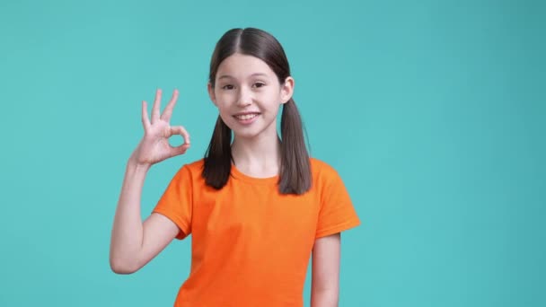 Schoolkid make okay symbol isolated cyan color background — Video Stock