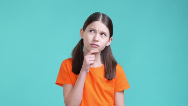 Smart schoolkid ponder decide dilemma great mind isolated cyan color background — Stok video