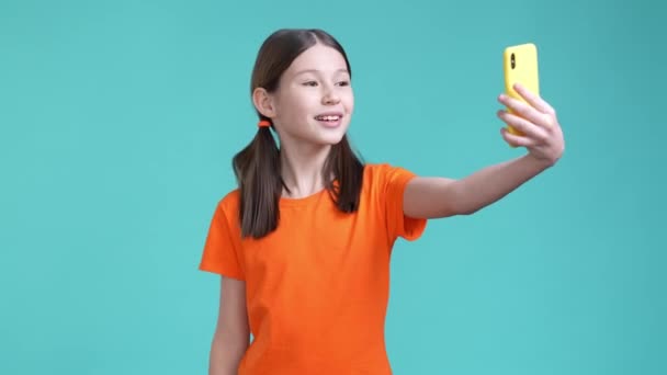 Modern schoolchild talk gadget vlog followers isolated cyan color background — Stockvideo
