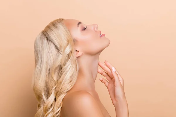 Profile side photo of stunning adorable lady touch neck lifting anti age wrinkles correction isolated on beige color background — 스톡 사진