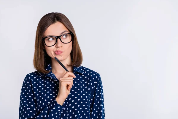 Portrait of attractive minded suspicious girl making decision copy blank space ad isolated over grey pastel color background — стоковое фото