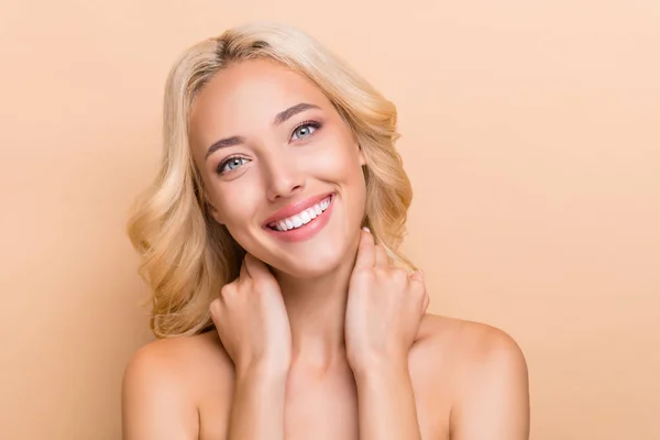 Portrait of attractive cheery shine wavy-haired girl touching pure neck daily domestic procedure isolated over beige pastel color background — Foto de Stock
