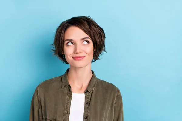 Photo of cute young bob hairdo lady look empty space wear khaki shirt isolated on blue color background — Stockfoto