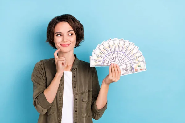 Photo of nice young short hairstyle lady look money wear khaki shirt isolated on blue color background — Zdjęcie stockowe