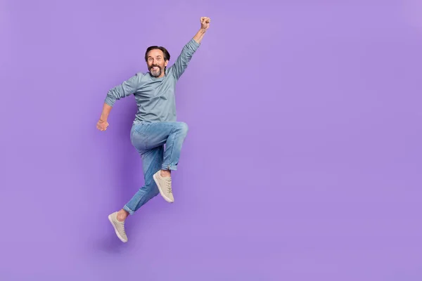 Full body profile side photo of cheerful mature man superhero jump isolated over purple color background — Stockfoto