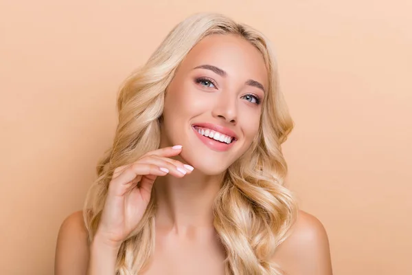 Portrait of attractive cheerful adorable wavy-haired girl touching soft skin cleansing pore isolated over beige pastel color background — ストック写真