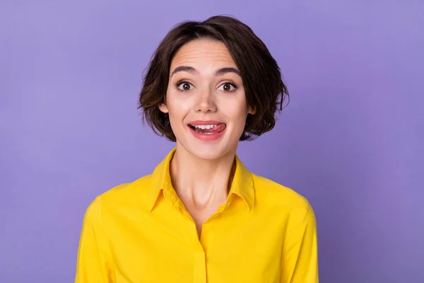 Photo of funky young hr lady lick lip wear yellow outfit isolated on violet color background — kuvapankkivalokuva