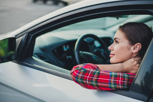 Profile side view portrait of attractive cheerful girl driving car looking at mirror on parking enjoying mood outdoors —  Fotos de Stock