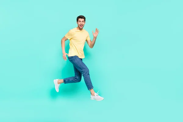 Full body profile portrait of excited energetic man running hurry speed isolated on teal color background — Stockfoto