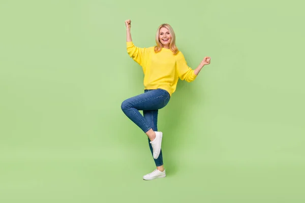 Full length photo of delighted aged lady celebrate lucky lottery champion fist up isolated green color background — Stockfoto