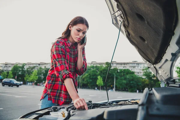 Portrait of beautiful girl taxi service driver calling support operator checking car examine broken brakes on parking outdoors — Stock fotografie