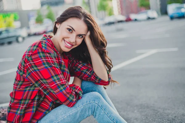 Profile side view portrait of attractive cheerful wavy-haired girl sitting on parking spending weekend streetstyle outdoors — ストック写真