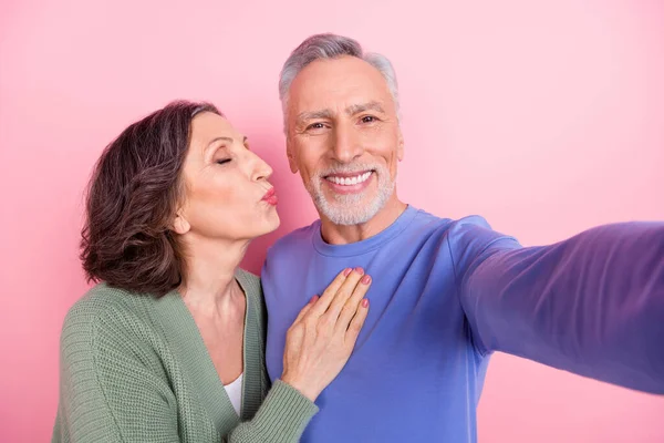 Self-portrait of two handsome beautiful tender sweet people kissing isolated over pink pastel color background —  Fotos de Stock