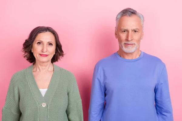 Portrait of two handsome beautiful content people team standing together isolated over pink pastel color background — стоковое фото