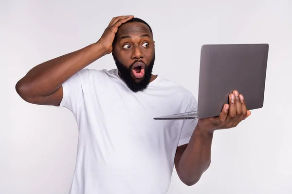 Photo of shocked funky guy dressed casual t-shirt arm head looking modern gadget isolated white color background