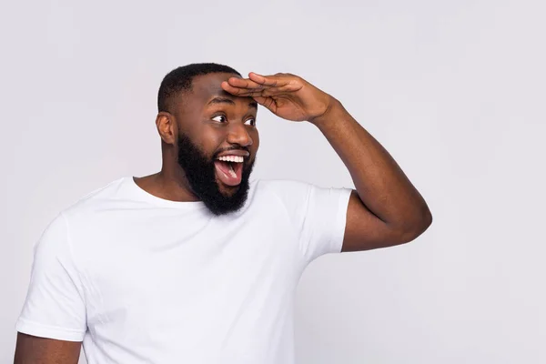 Photo of funky amazed guy dressed casual t-shirt arm forehead looking far away empty space isolated white color background — Stockfoto