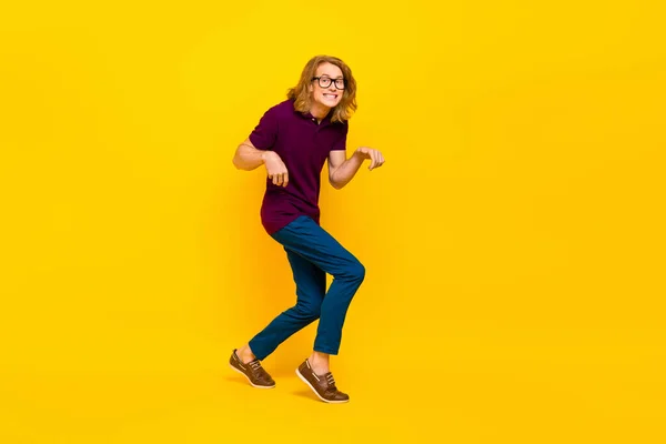 Full size portrait of positive cheerful person sneaky walking toothy smile isolated on yellow color background — Stock Photo, Image