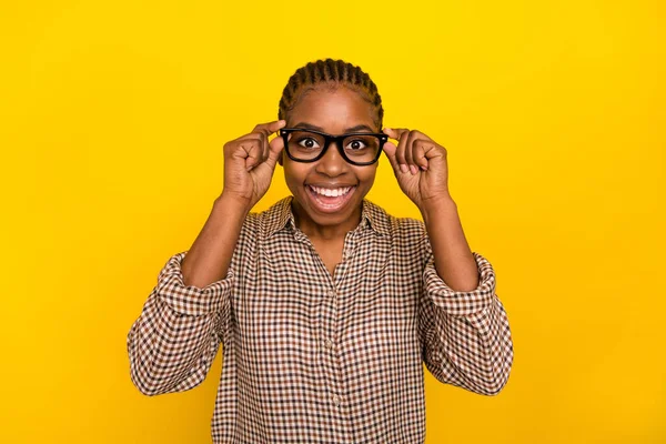 Photo of excited adorable lady dressed checkered shirt arms spectacles smiling isolated yellow color background — Stockfoto