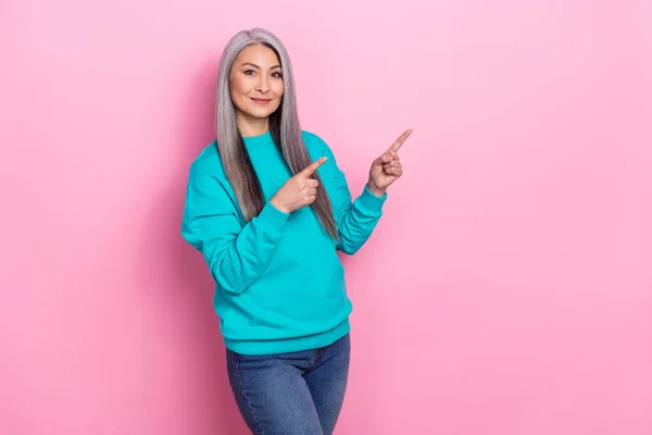 Photo of pretty positive person direct fingers empty space proposition isolated on pink color background — Stok fotoğraf