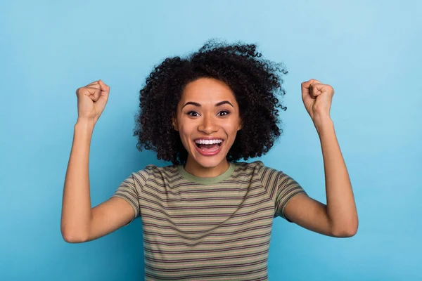Photo of delighted lady rejoicing winning fan champion fist up isolated on blue color background — Stockfoto