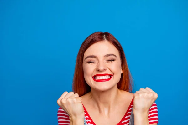 Photo of overjoyed satisfied girl closed eyes raise fists up celebrate triumph isolated on blue color background — Stock Fotó