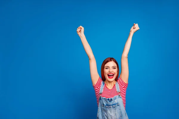 Portrait of delighted glad person raise fists up shout yeah hooray isolated on blue color background — Stock fotografie
