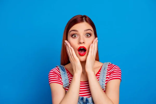 Photo of charming impressed young lady dressed red clothes arms cheeks smiling isolated blue color background — ストック写真