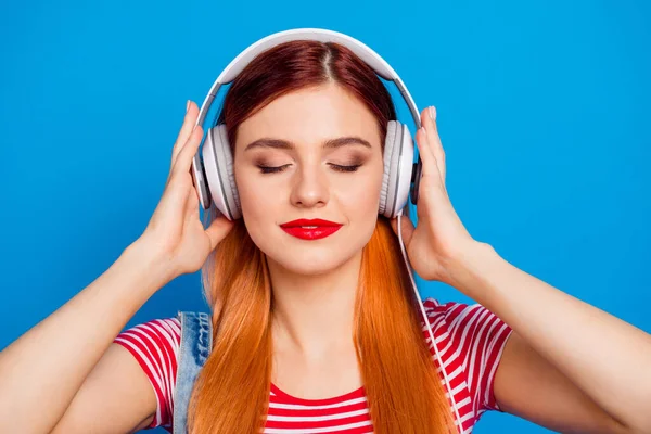 Photo of sweet adorable young lady dressed denim clothes enjoying songs earphones isolated blue color background — Stockfoto