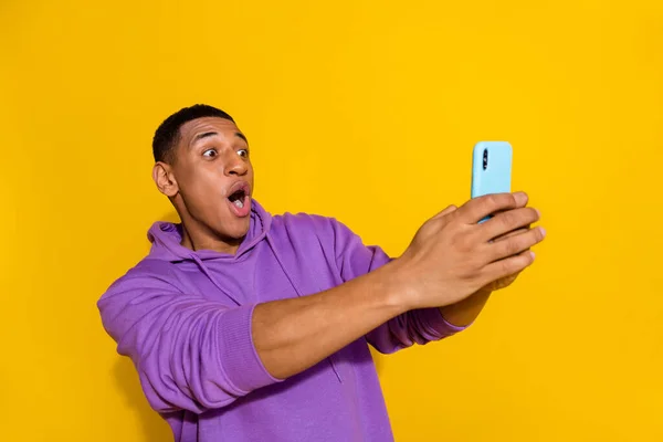 Portrait of attractive trendy amazed guy using gadget fast speed wow blog influencer isolated over bright yellow color background — Stockfoto