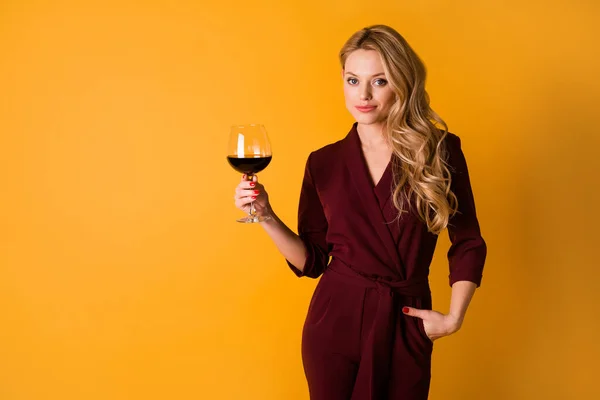 Portrait of confident gorgeous girl put hand pocket hold wine isolated on yellow color background — Foto de Stock