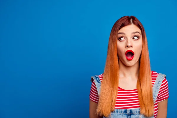 Photo of astonished pretty girl open mouth look interested empty space isolated on blue color background — Stock Fotó